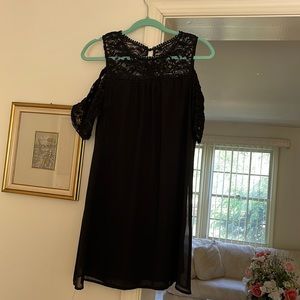 Black straight dress with lace neckline and off the shoulder cap sleeves.